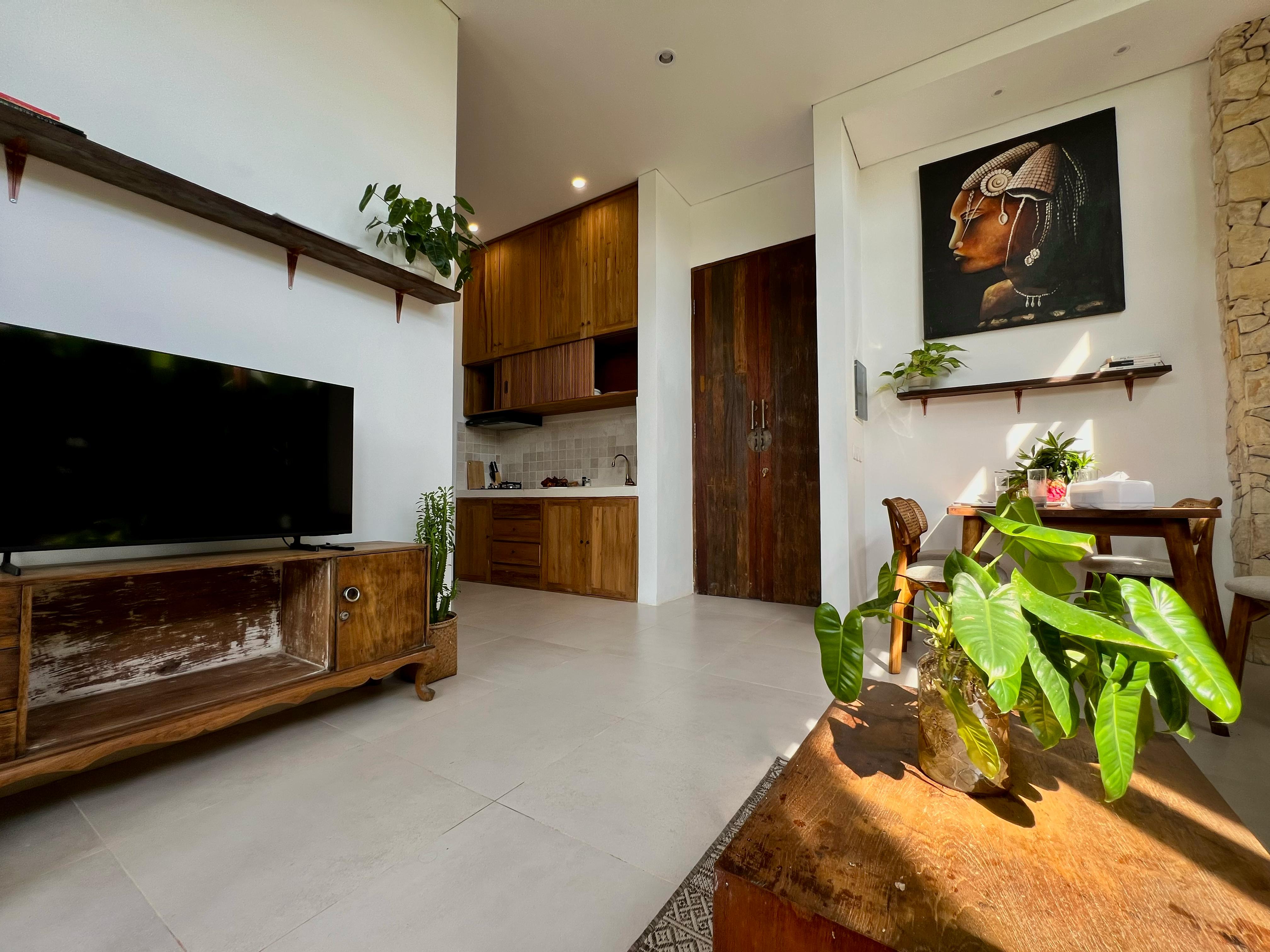 Tiny Villa Jimbaran - Organic modern living space with vintage wood furniture and African art